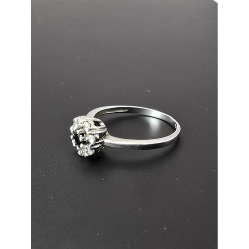 225 - A pretty as new 925 silver cluster ring inset with very sparkly clear CZ crystal stones with a black... 