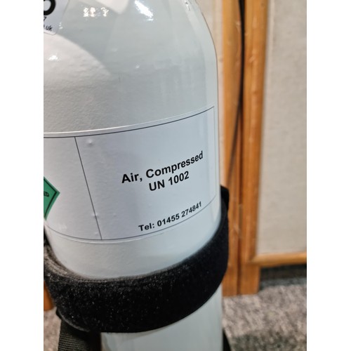 311A - Canister of CO2 gas marked Air Compressed UN 1002, complete with carrying strap and connector for ga... 