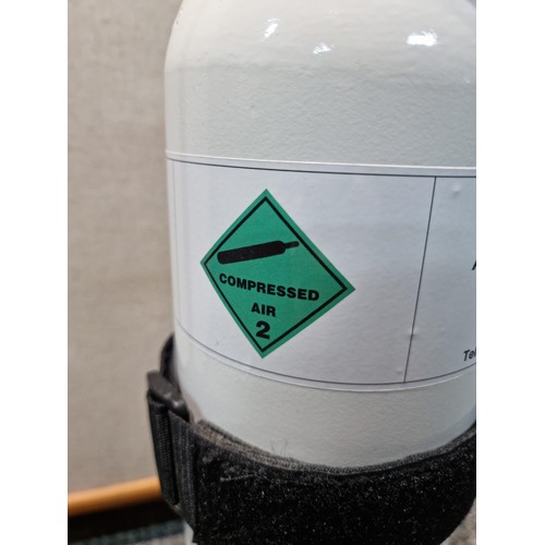 311A - Canister of CO2 gas marked Air Compressed UN 1002, complete with carrying strap and connector for ga... 