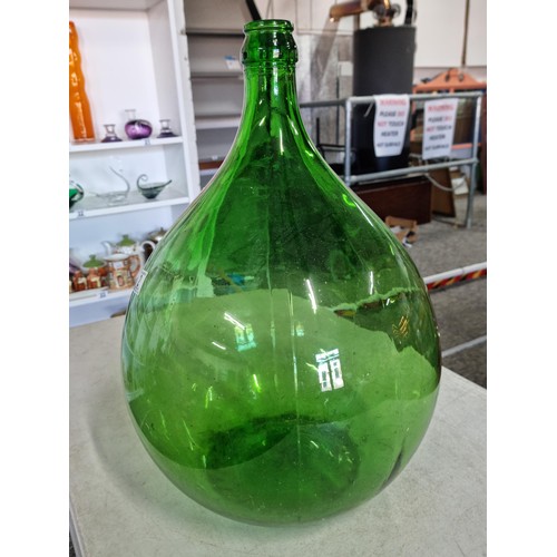 2 - A large green glass carboy in good order with no chips along with an artificial succulent plant. The... 