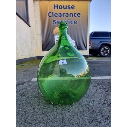 2 - A large green glass carboy in good order with no chips along with an artificial succulent plant. The... 