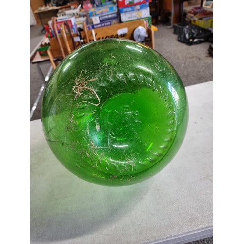 2 - A large green glass carboy in good order with no chips along with an artificial succulent plant. The... 