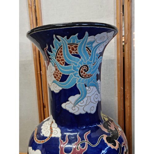 7 - A very large and impressive Chinese floor standing vase with a very colourful dragon design, in very... 