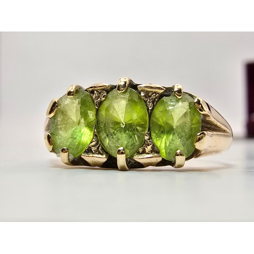 253 - A stunning antique hallmarked 15ct yellow gold peridot 3 stone ring, inset with 3 large faceted peri... 