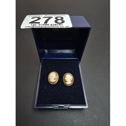 255 - A pair of pretty hallmarked 9ct yellow gold cameo stud earrings featuring a carved cameo shell with ... 