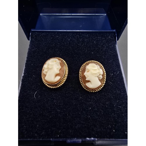 255 - A pair of pretty hallmarked 9ct yellow gold cameo stud earrings featuring a carved cameo shell with ... 