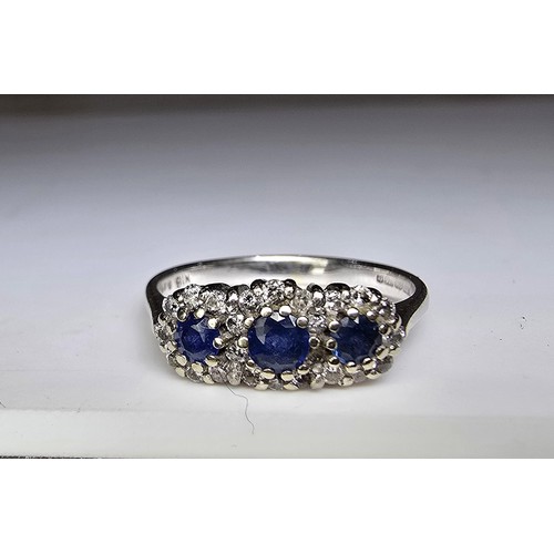 258 - A stunning hallmarked 18ct white gold sapphire and diamond ring featuring 3 large vibrant natural ea... 