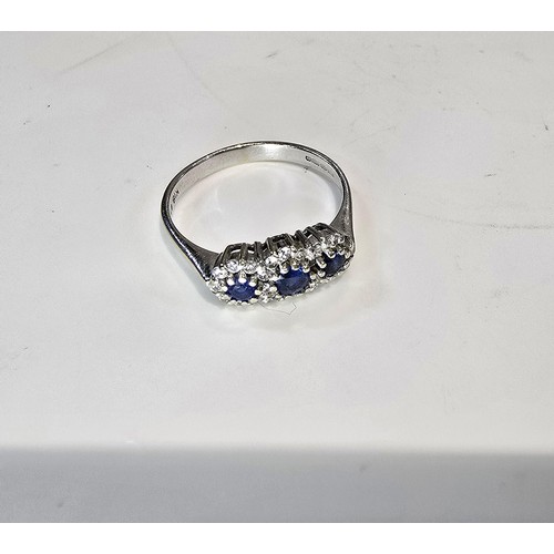 258 - A stunning hallmarked 18ct white gold sapphire and diamond ring featuring 3 large vibrant natural ea... 