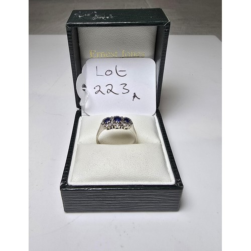 258 - A stunning hallmarked 18ct white gold sapphire and diamond ring featuring 3 large vibrant natural ea... 