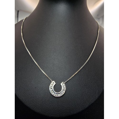 267 - A pretty as new hallmarked 9ct white gold necklace featuring a horseshoe pendant inset with sparkly ... 