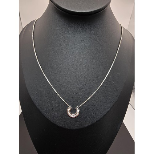 267 - A pretty as new hallmarked 9ct white gold necklace featuring a horseshoe pendant inset with sparkly ... 