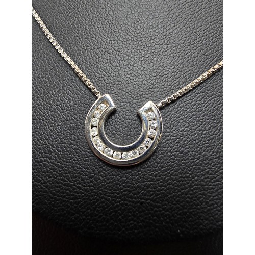 267 - A pretty as new hallmarked 9ct white gold necklace featuring a horseshoe pendant inset with sparkly ... 