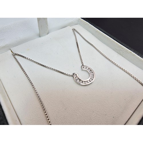 267 - A pretty as new hallmarked 9ct white gold necklace featuring a horseshoe pendant inset with sparkly ... 