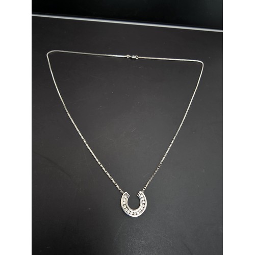 267 - A pretty as new hallmarked 9ct white gold necklace featuring a horseshoe pendant inset with sparkly ... 