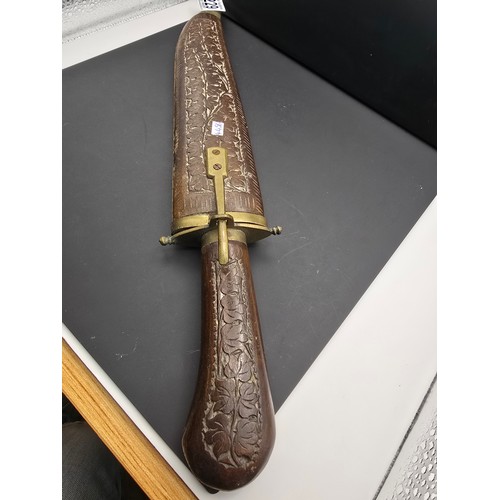 229 - A good early vintage Indian carved wood knife with sheath featuring a well carved handle and wooden ... 