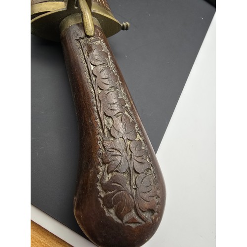 229 - A good early vintage Indian carved wood knife with sheath featuring a well carved handle and wooden ... 