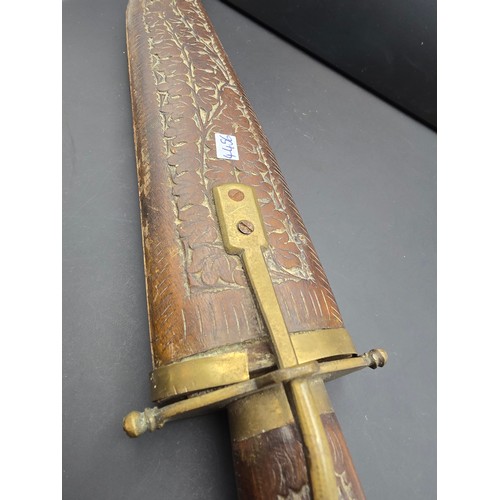 229 - A good early vintage Indian carved wood knife with sheath featuring a well carved handle and wooden ... 