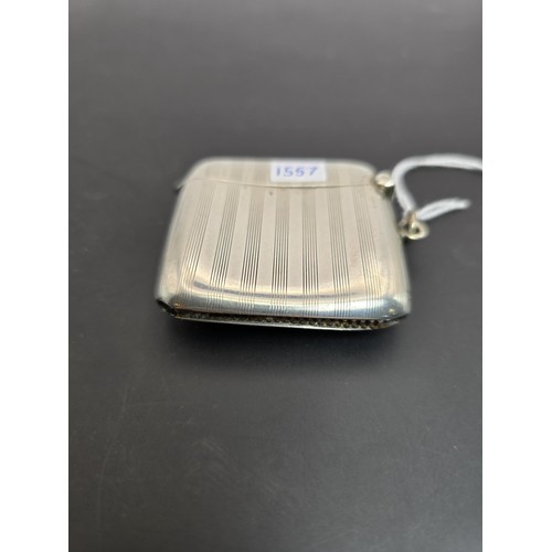 243 - A good quality heavy hallmarked silver Vesta case having an engraved striped design, featuring a str... 