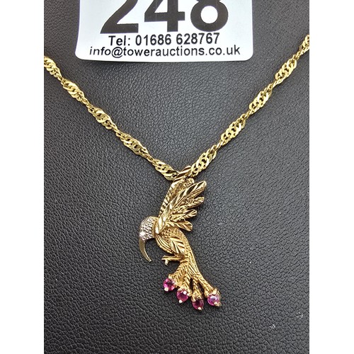 248 - A very pretty hallmarked 9ct yellow gold hummingbird pendant set with 4 faceted ruby gemstones to th... 