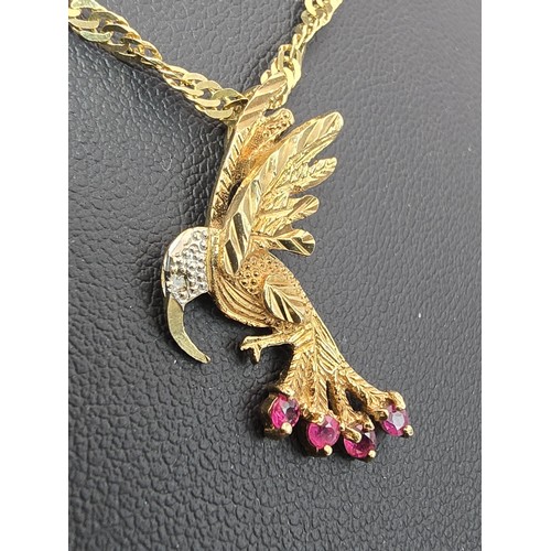 248 - A very pretty hallmarked 9ct yellow gold hummingbird pendant set with 4 faceted ruby gemstones to th... 