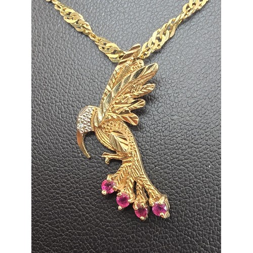 248 - A very pretty hallmarked 9ct yellow gold hummingbird pendant set with 4 faceted ruby gemstones to th... 