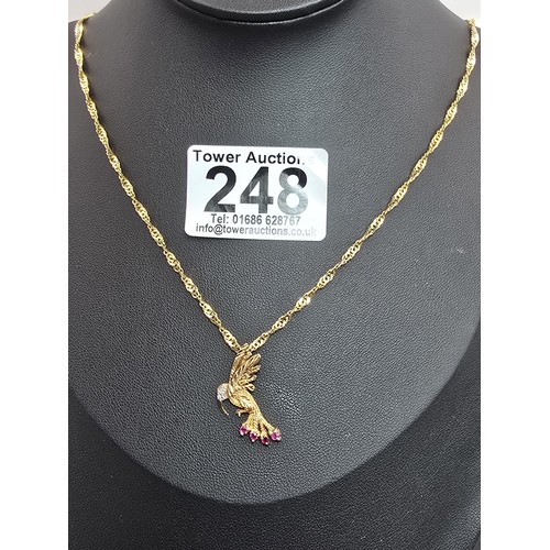 248 - A very pretty hallmarked 9ct yellow gold hummingbird pendant set with 4 faceted ruby gemstones to th... 