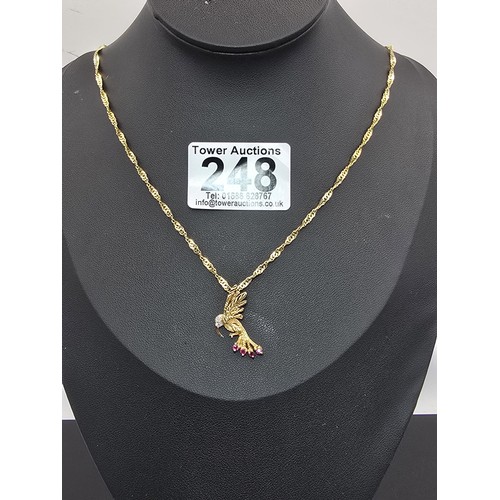 248 - A very pretty hallmarked 9ct yellow gold hummingbird pendant set with 4 faceted ruby gemstones to th... 