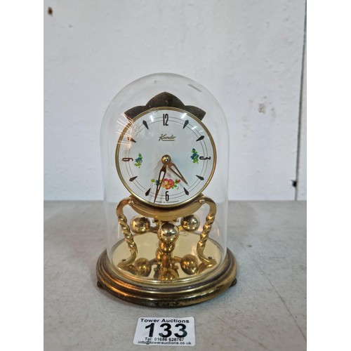 133 - Good quality anniversary Kundo clock in display glass dome case, in working order with floral decora... 