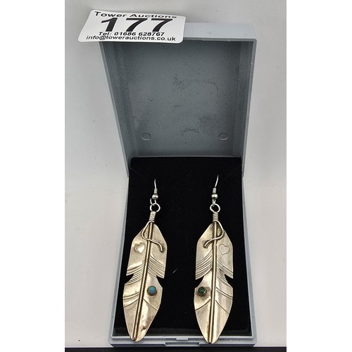 177 - A pair of large 925 silver long drop earrings in the form of Navajo feathers, inset with a turquoise... 