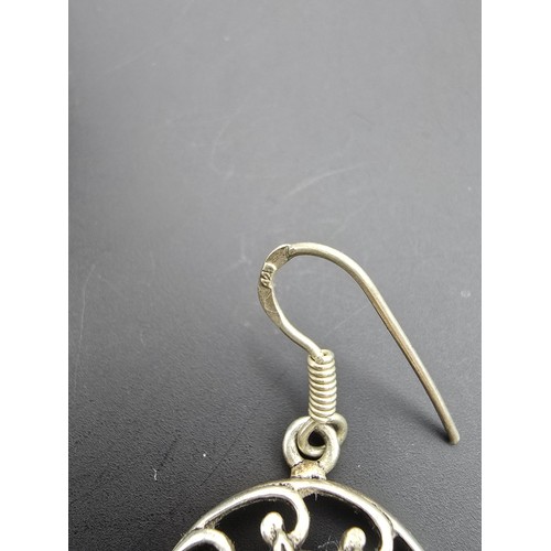 181 - A pair of attractive vintage 925 silver drop earrings having a pierced design, inset with large face... 