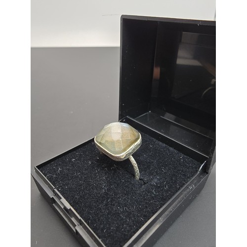 182 - A pretty 925 silver ring inset with a large cushion cut labradorite gemstone, featuring beautiful fl... 