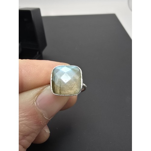 182 - A pretty 925 silver ring inset with a large cushion cut labradorite gemstone, featuring beautiful fl... 