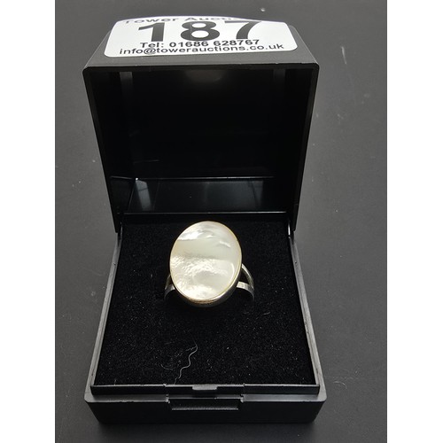 187 - Pretty 925 Silver ring inset with a large oval mother of pearl stone which flashes beautifully in th... 