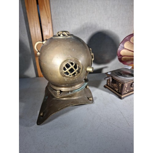 299 - Good quality cast iron decorative gramophone along with a brass decorative small divers helmet, helm... 