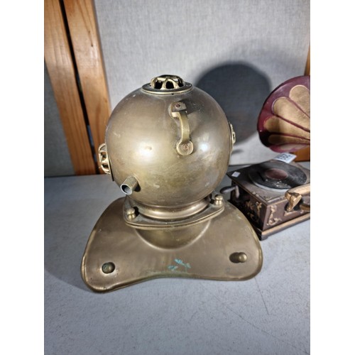 299 - Good quality cast iron decorative gramophone along with a brass decorative small divers helmet, helm... 