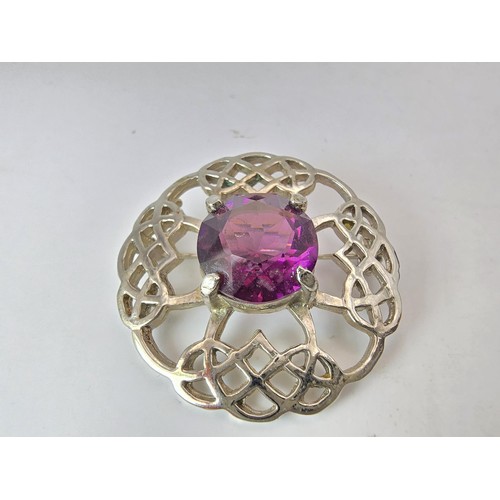 196 - Pretty Scottish Celtic brooch set with a large faceted purple glass stone, marked DB Scotland.