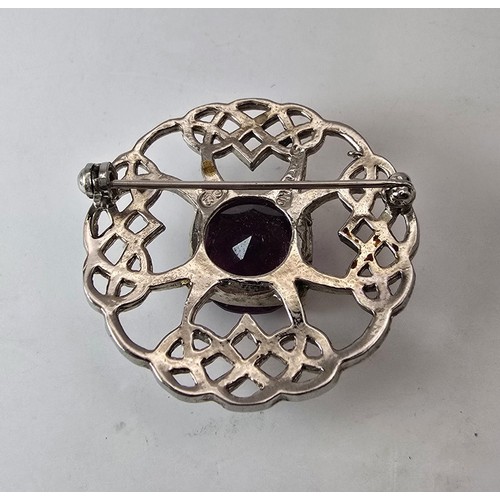 196 - Pretty Scottish Celtic brooch set with a large faceted purple glass stone, marked DB Scotland.