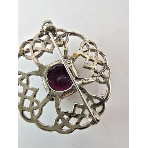 196 - Pretty Scottish Celtic brooch set with a large faceted purple glass stone, marked DB Scotland.