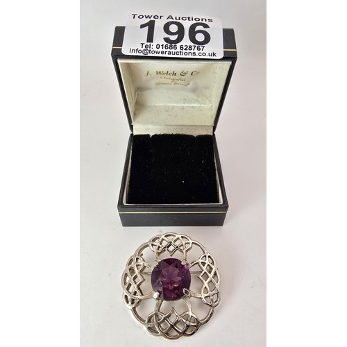 196 - Pretty Scottish Celtic brooch set with a large faceted purple glass stone, marked DB Scotland.