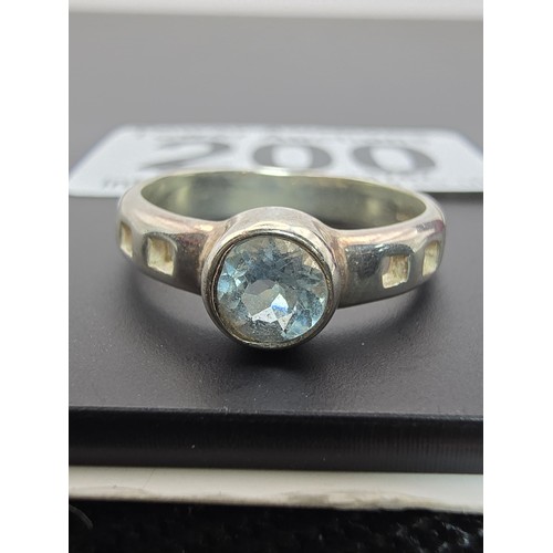 200 - Pretty Hallmarked 925 Silver ring inset with a faceted blue topaz gem stone with a vibrant blue colo... 