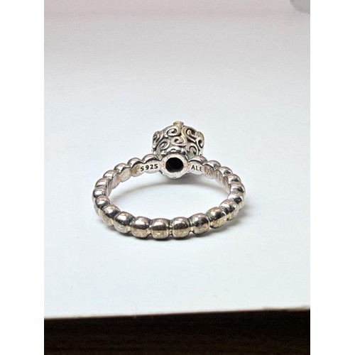 203 - A genuine Pandora 925 silver ring with an ornate design inset with a large faceted black tourmaline ... 