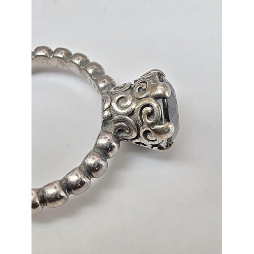 203 - A genuine Pandora 925 silver ring with an ornate design inset with a large faceted black tourmaline ... 