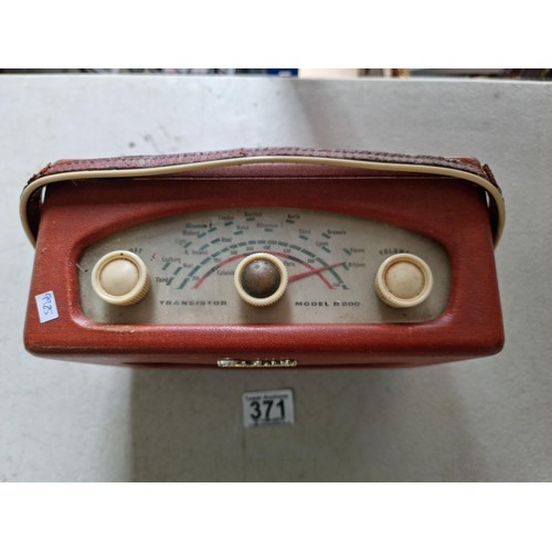 371 - A small portable Roberts transistor radio model R-200, battery operated with built in aerial, along ... 