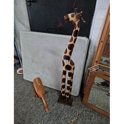 372 - 2 fair trade items to include a large wooden giraffe and a wooden duck by DCUK. The giraffe has a he... 