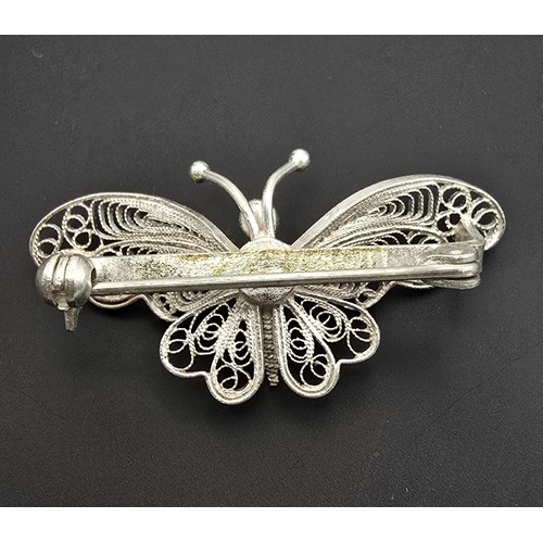 213 - A pretty 925 silver butterfly brooch having a filigree design, in as new condition and boxed. Has a ... 