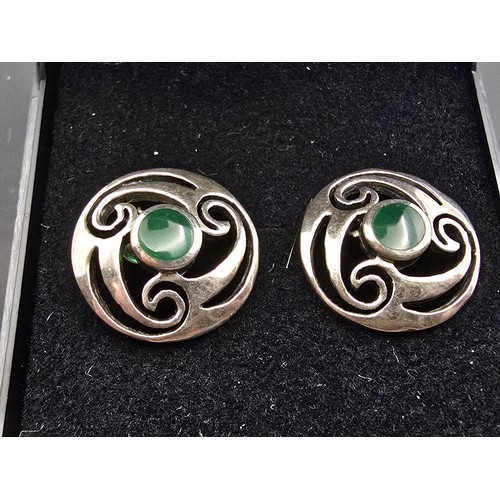 214 - A pair of hallmarked silver 925 silver stud earrings with a Celtic design inset with vibrant green c... 