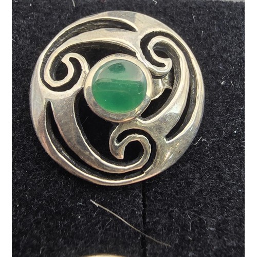 214 - A pair of hallmarked silver 925 silver stud earrings with a Celtic design inset with vibrant green c... 