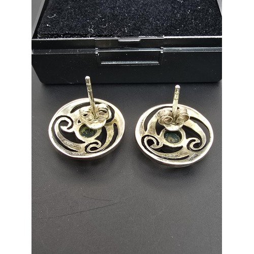 214 - A pair of hallmarked silver 925 silver stud earrings with a Celtic design inset with vibrant green c... 