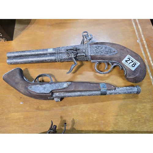 278 - 2x replica 18th century flintlock pistols each having a different design, made out of solid wood wit... 