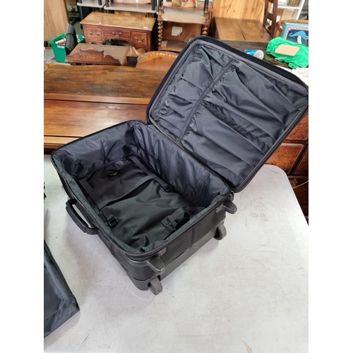 389 - Pair of very good quality Briggs & Riley suitcases in very good condition, along with a suit a suit ... 